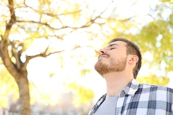 A man with his eyes closed and his mouth open.