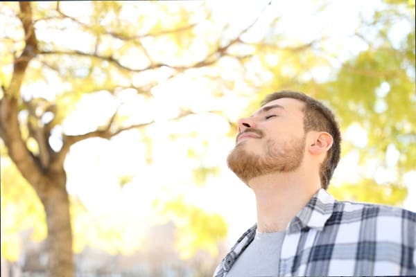 A man with his eyes closed and his mouth open.