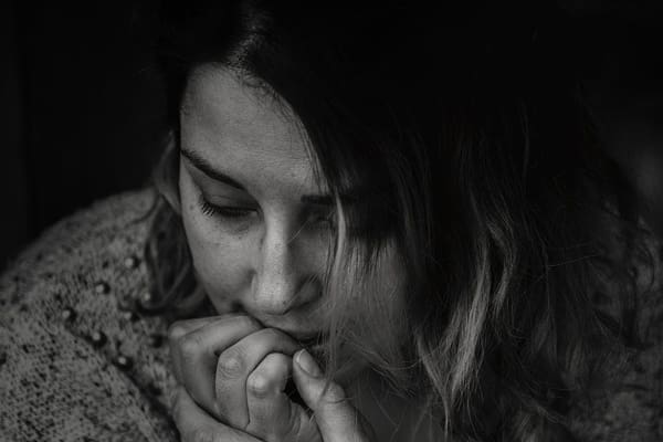 A woman with her hands over her mouth.