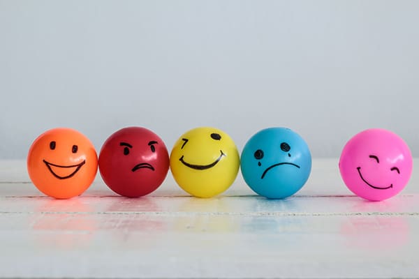 A row of colorful balls with faces drawn on them.