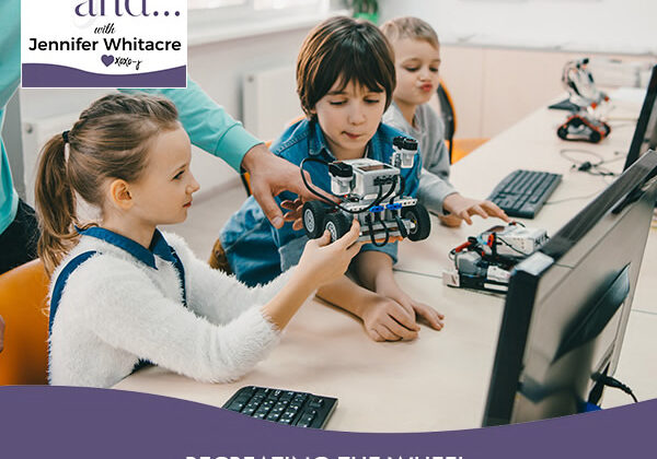 A group of children sitting at a computer desk.